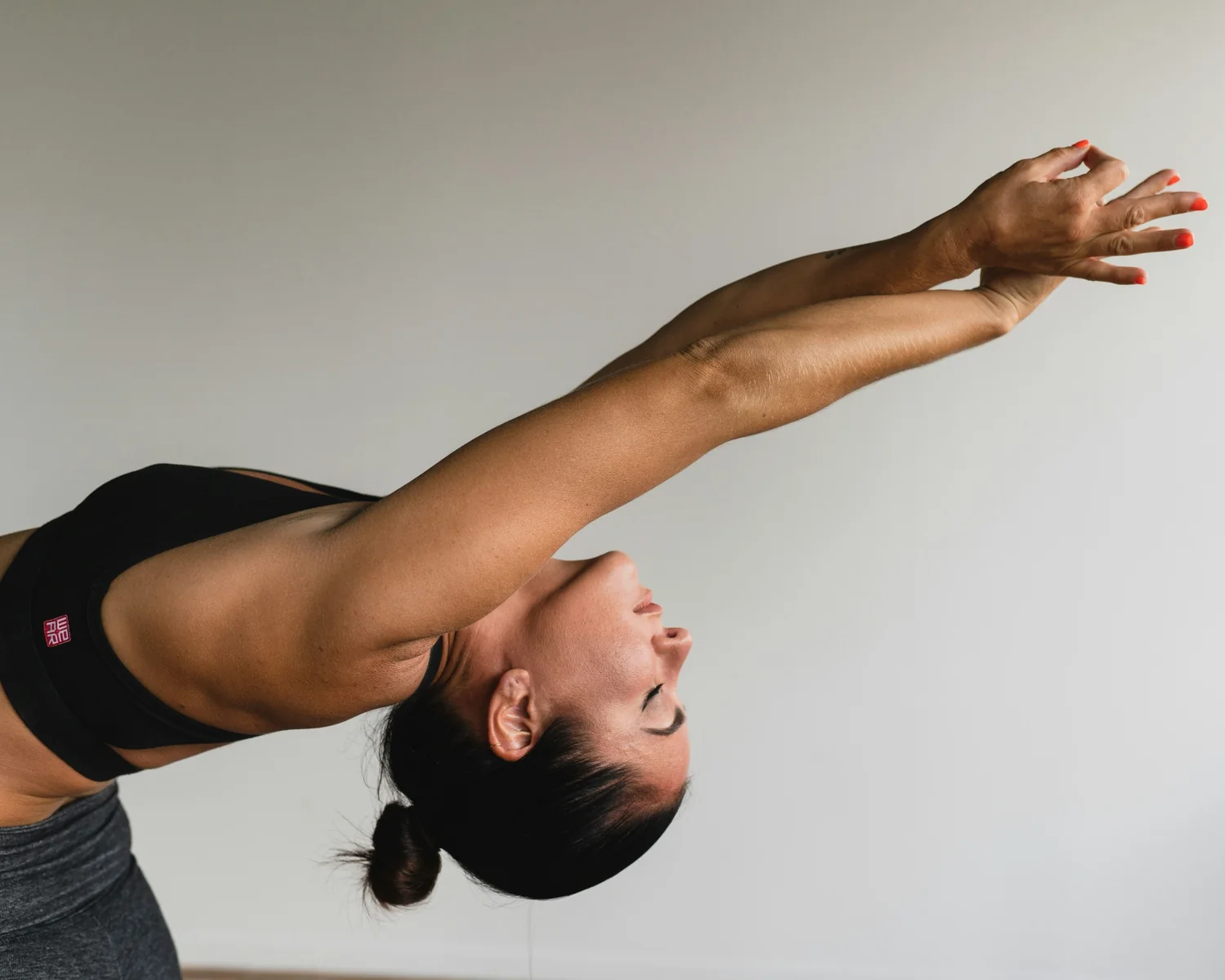 Woman moving gracefully through a yoga backbend